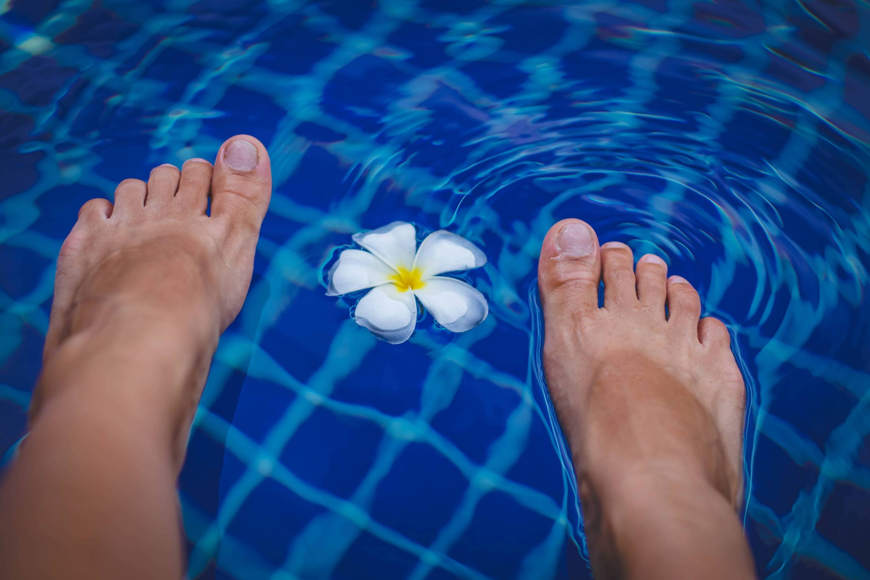 Bare feet in a swimming pool